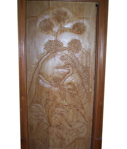 carved wood interior or entry door with heron