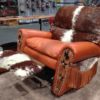 leather and cowhide western recliner with long fringe and tooled arms