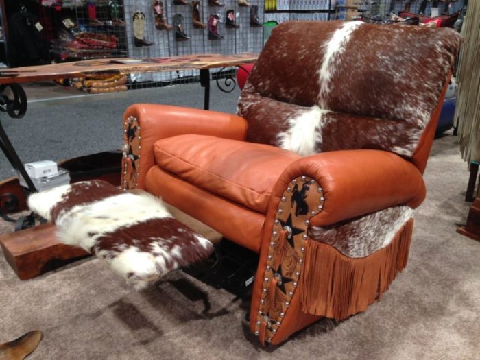 leather and cowhide western recliner with long fringe and tooled arms