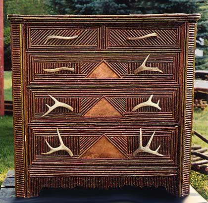 Adirondack style dresser with antler drawer handles and full twig coverage