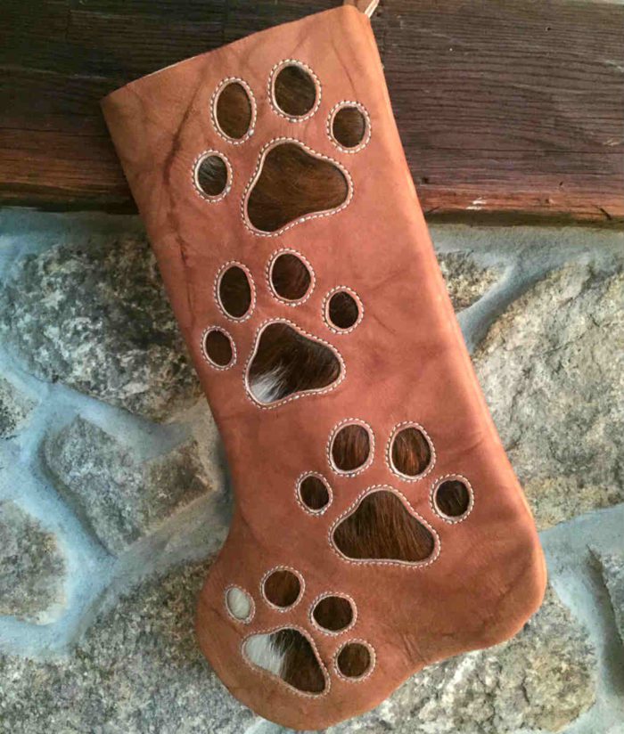 cowhide Christmas stocking with dog paw prints