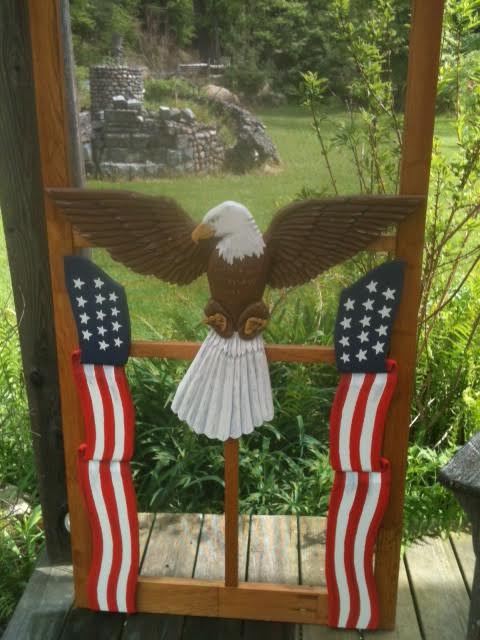 carved wood screen door with eagle and American flags