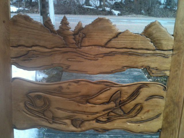 close up of fish in the river on carved wood screen door