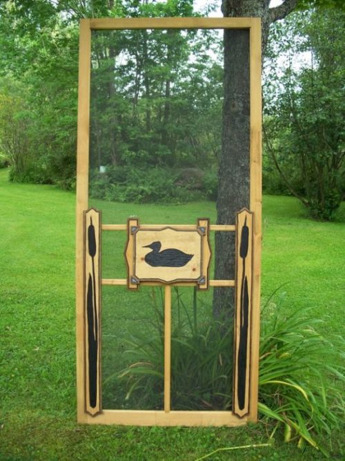 wood screen door with carved duck on center panel and cattail side panels