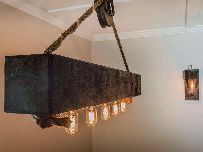 Rustic wood beam chandelier with rope and pully