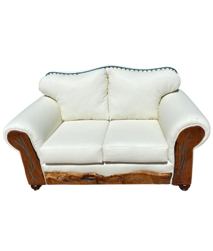white leather pillowback love seat with curved top and decorative tacks.