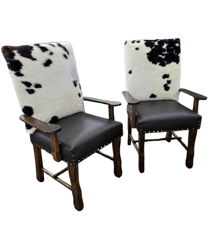 pair of cowhide dining chairs with arms